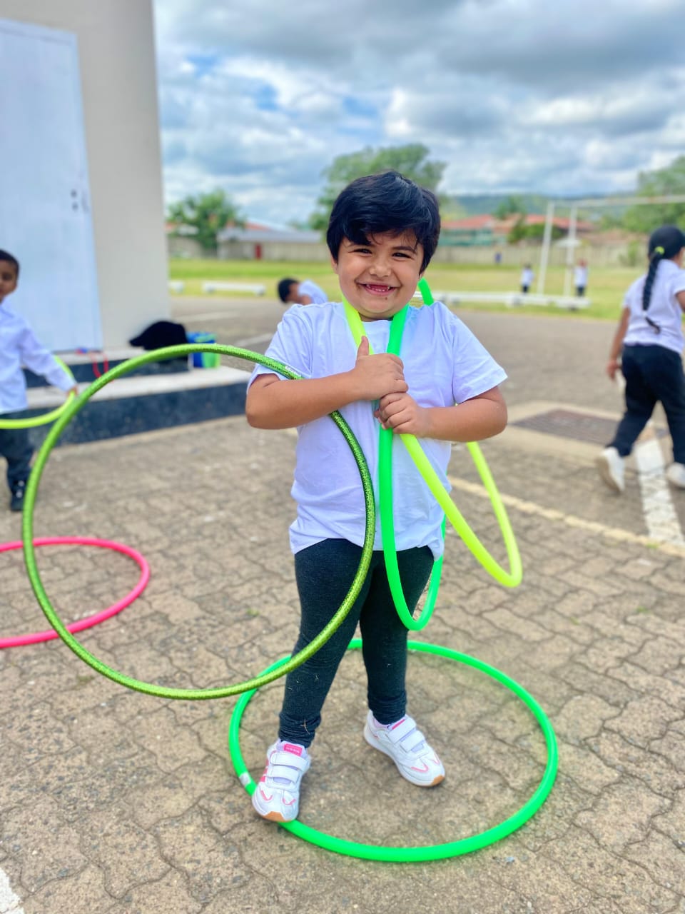 Learner playing with hoops outdoors