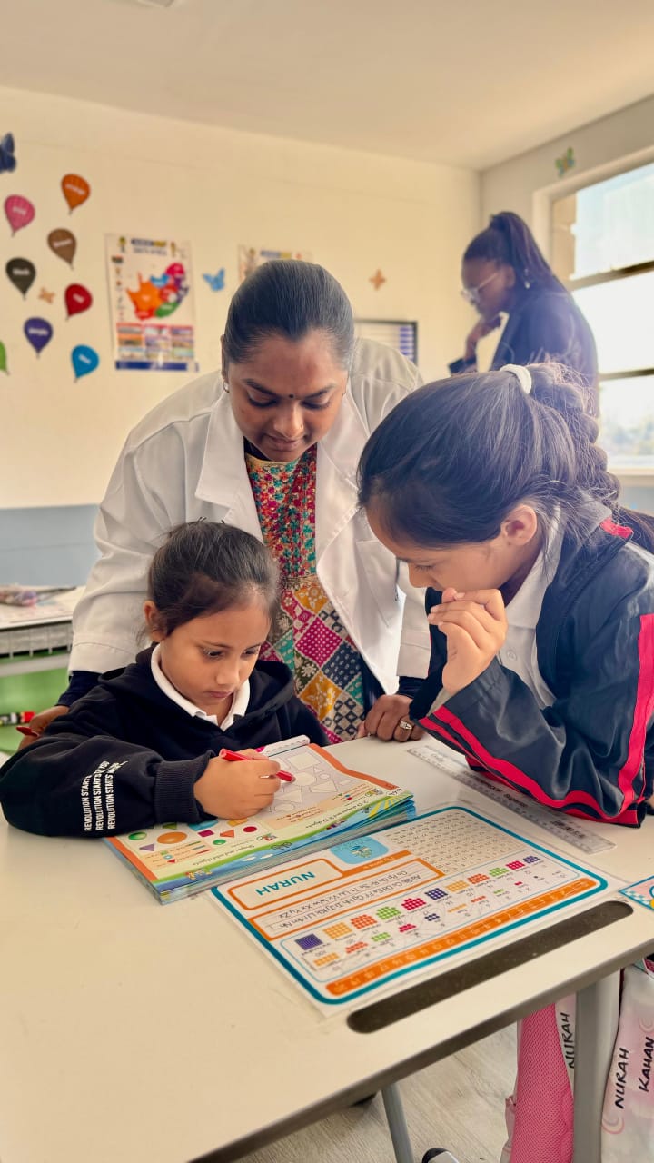 Teacher supporting learners during an activity
