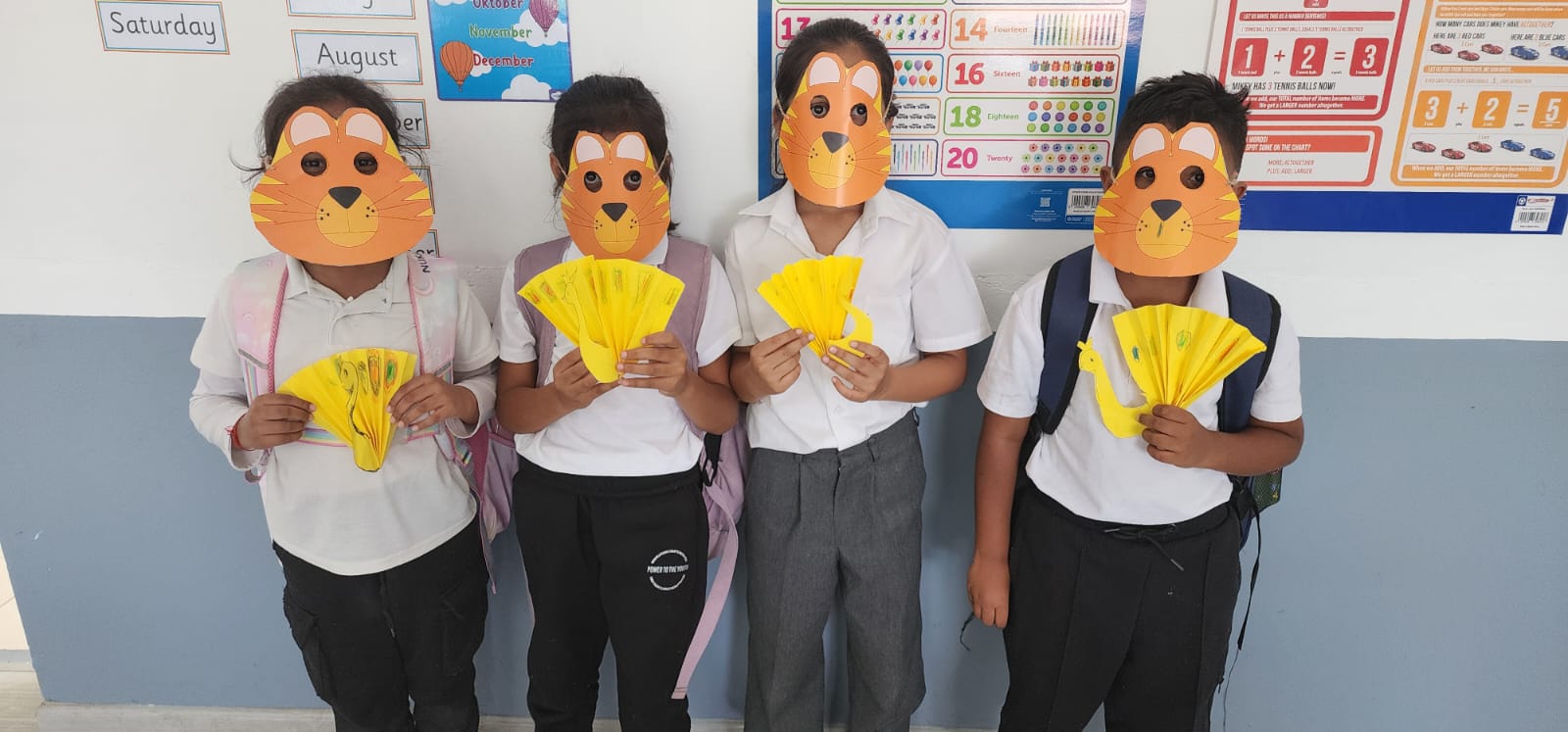Learners holding craft work