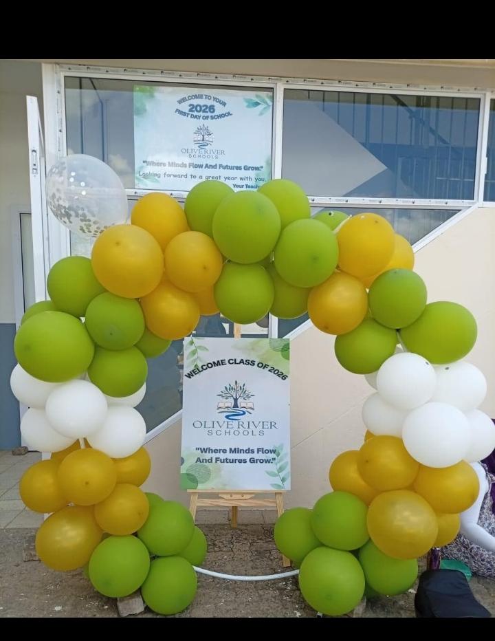 Olive River Schools entrance with green and gold balloons