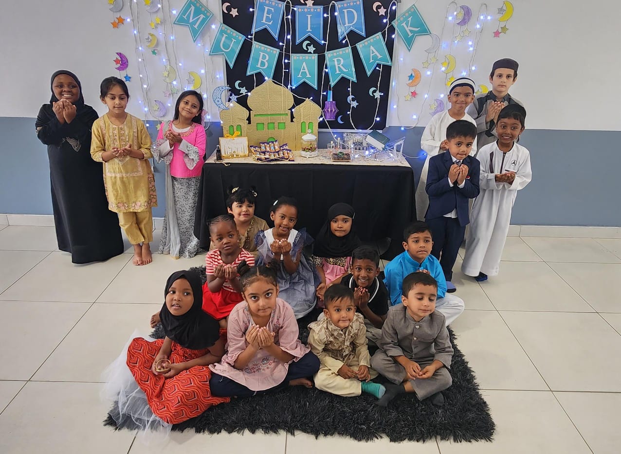 Learners gathered around a Mubarak celebration display
