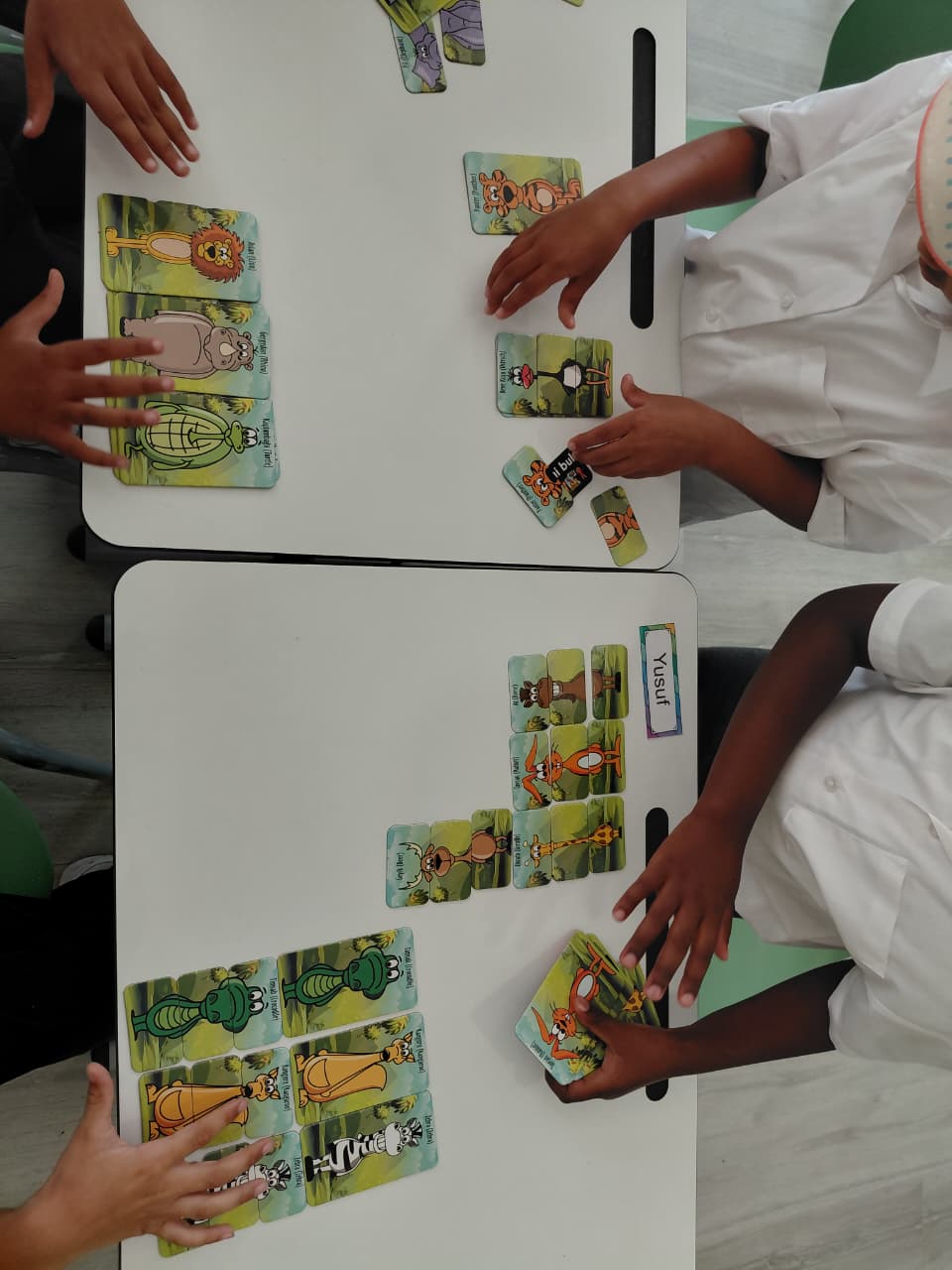 Learners matching animal cards during a table activity