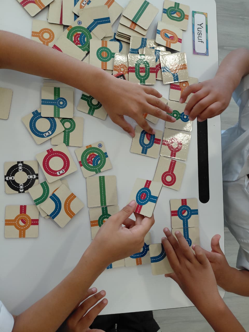 Learners arranging road puzzle pieces together